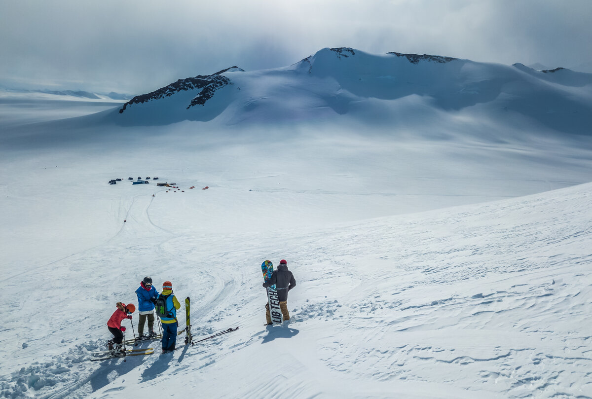 Guests ski and snowboard above Three Glaciers Retreat