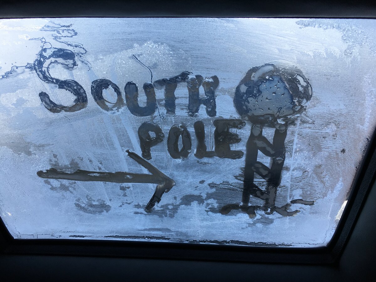 South Pole is drawn on the icy window of the Basler during a flight to the South Pole