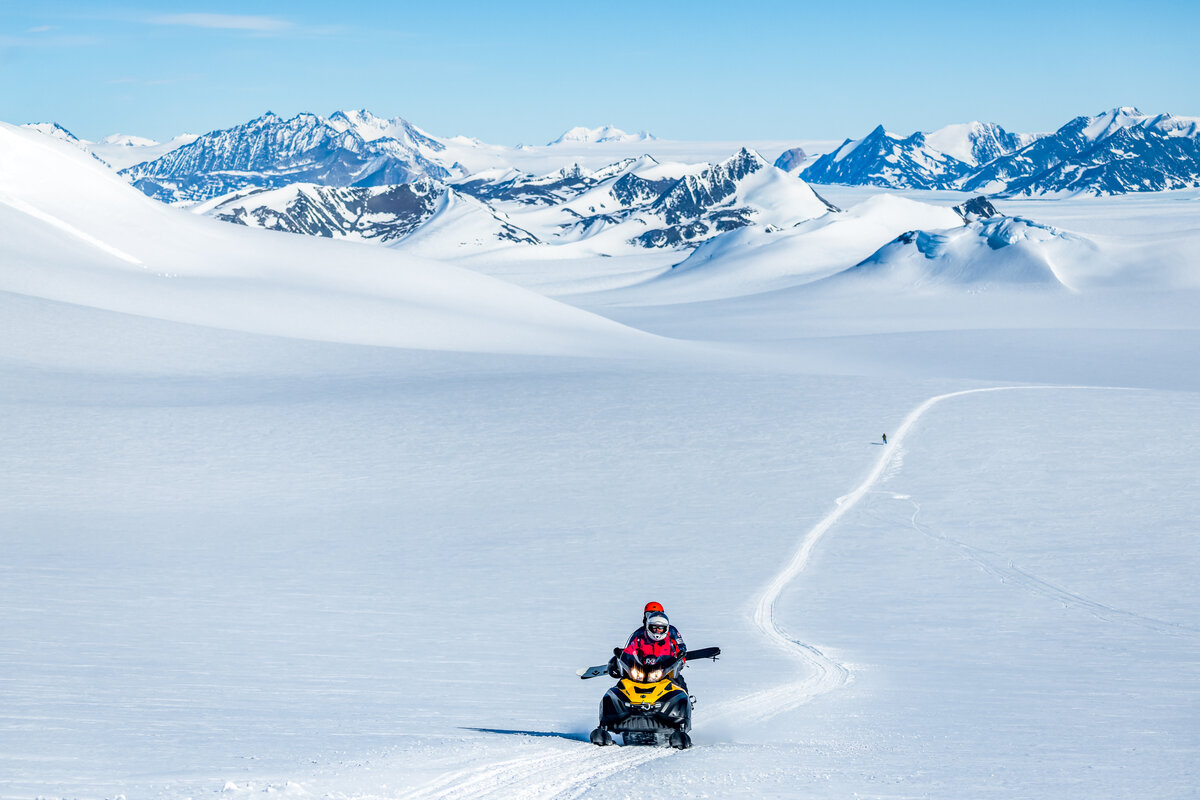 Snowboarders seek out powder by snowmobile